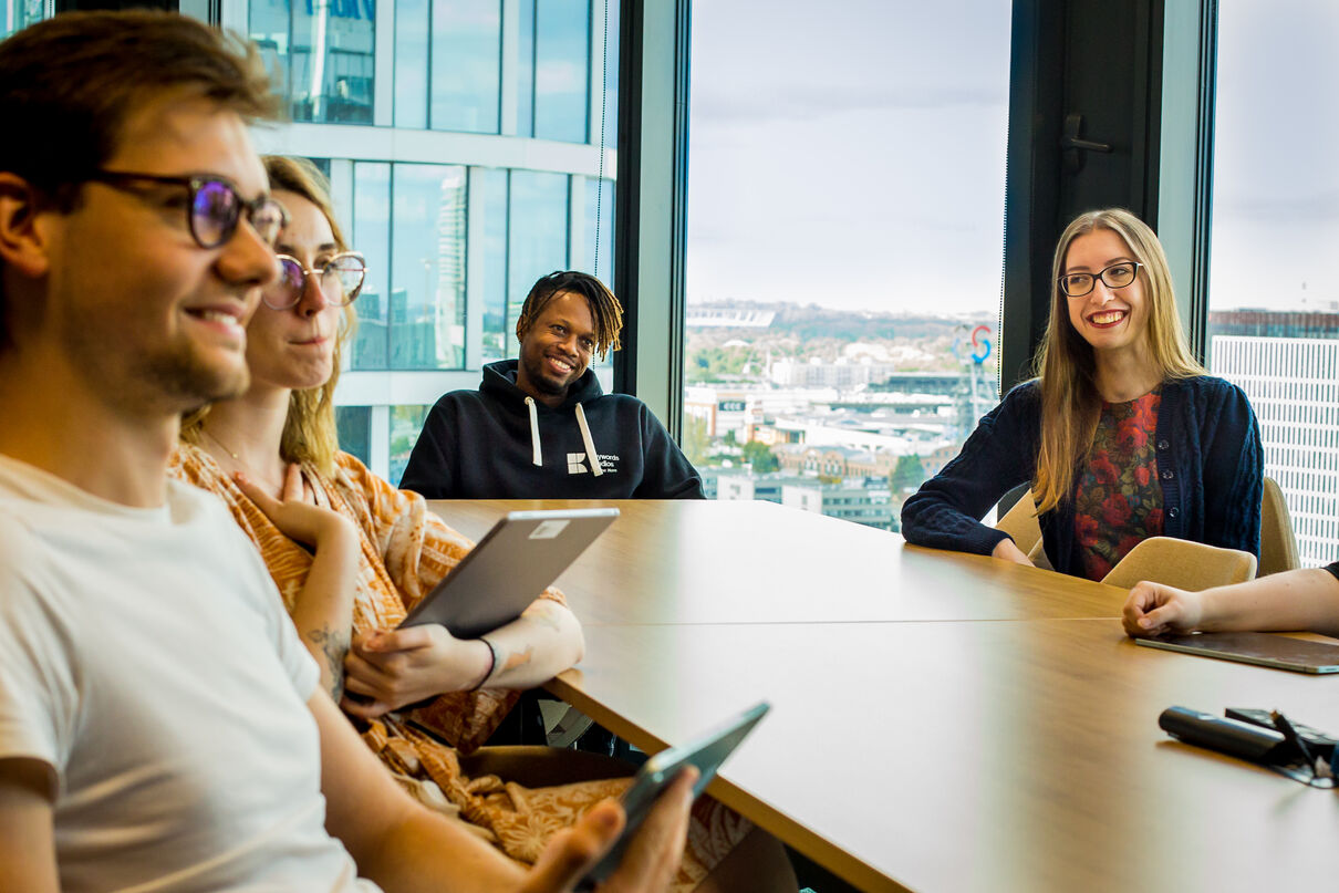 Three people sitting at a conference table